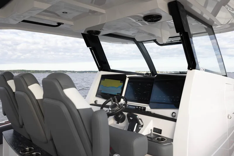 Slide: The Image of 2025 Fountain 43 SCX boat cockpit with advanced navigation systems and luxurious seating. - 8