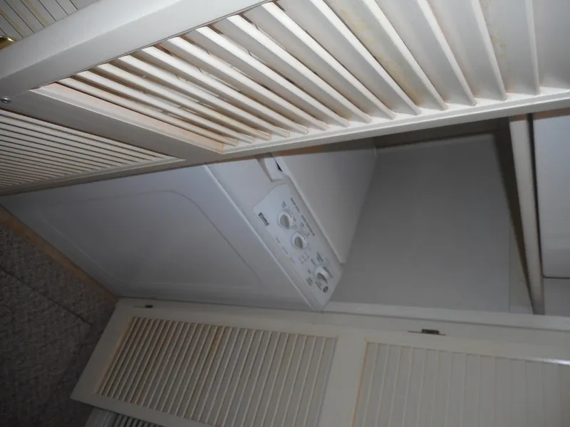 Slide: The Image of Laundry area with washer-dryer unit in 1995 Stardust Cruisers The Verdict houseboat. - 11