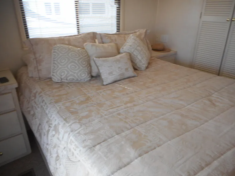 Slide: The Image of Luxurious bedroom in 1995 Stardust Cruisers The Verdict houseboat with elegant bedding. - 12