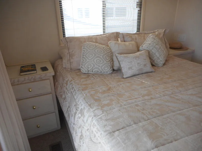 Slide: The Image of Cozy bedroom in 1995 Stardust Cruisers The Verdict houseboat with elegant bedding and side table. - 13