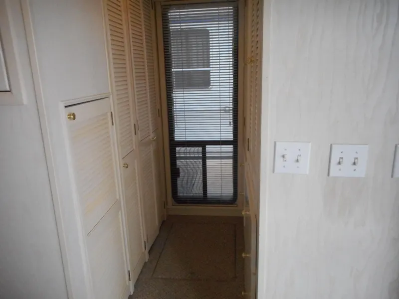 Slide: The Image of Narrow hallway in 1995 Stardust Cruisers The Verdict houseboat with closet doors and window. - 14