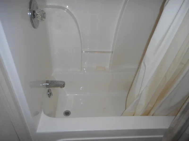 Slide: The Image of 1995 Stardust Cruisers The Verdict bathtub with shower curtain and soap holder. - 19