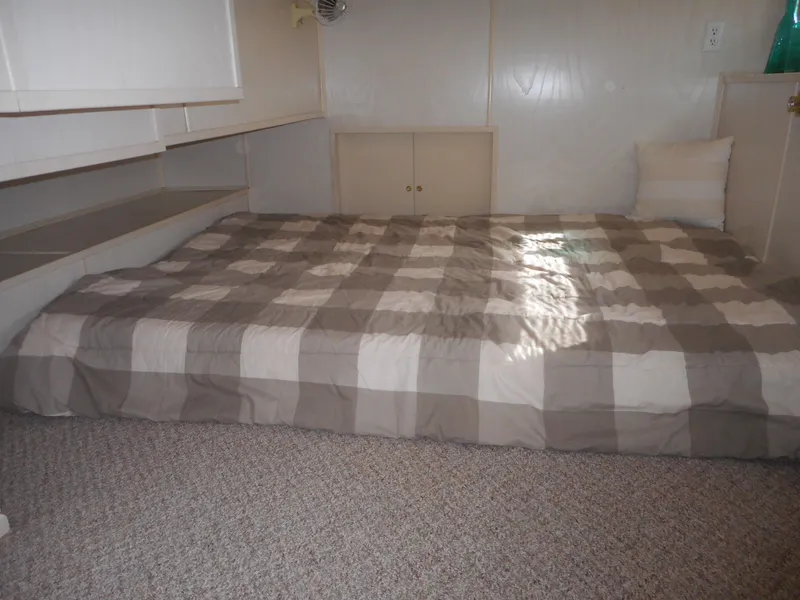 Slide: The Image of Interior bedroom of 1995 Stardust Cruisers The Verdict houseboat with checkered bedding. - 22