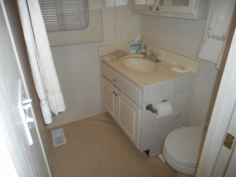 Slide: The Image of Bathroom in 1995 Stardust Cruisers The Verdict houseboat with sink, toilet, and towel rack. - 25