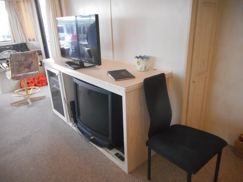 Slide: The Image of Living area in 1995 Stardust Cruisers The Verdict houseboat with TV and seating. - 31