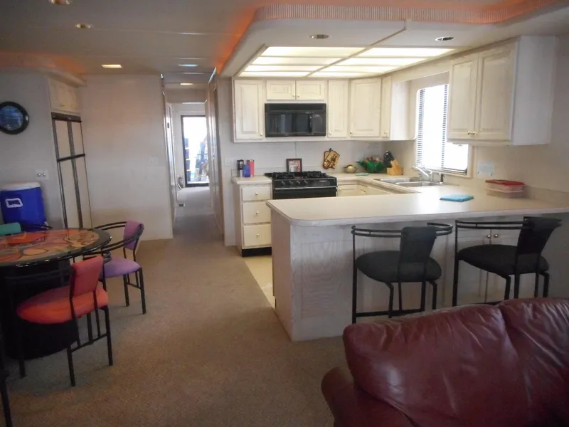 Slide: The Image of Interior of 1995 Stardust Cruisers The Verdict houseboat with kitchen and dining area. - 32