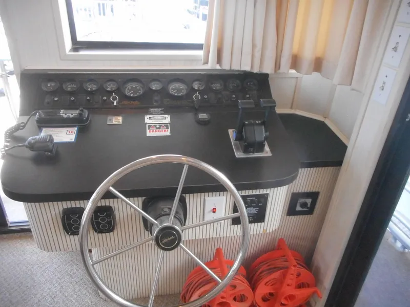 Slide: The Image of Control panel of 1995 Stardust Cruisers The Verdict houseboat with steering wheel and gauges. - 35