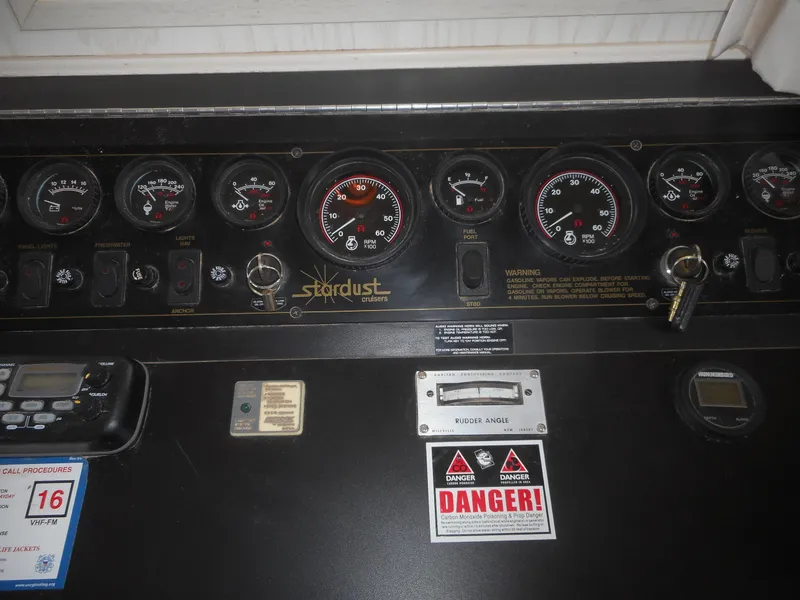 Slide: The Image of Control panel of a 1995 Stardust Cruisers The Verdict houseboat with gauges and warning labels. - 36