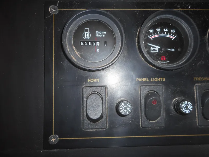 Slide: The Image of Control panel of 1995 Stardust Cruisers The Verdict with engine hours and switches. - 37
