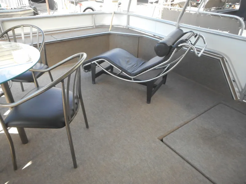 Slide: The Image of 1995 Stardust Cruisers The Verdict houseboat interior with lounge chair and dining area. - 39