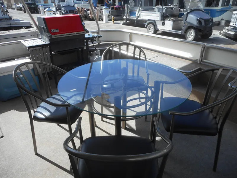 Slide: The Image of Glass table and chairs on 1995 Stardust Cruisers The Verdict houseboat deck. - 40