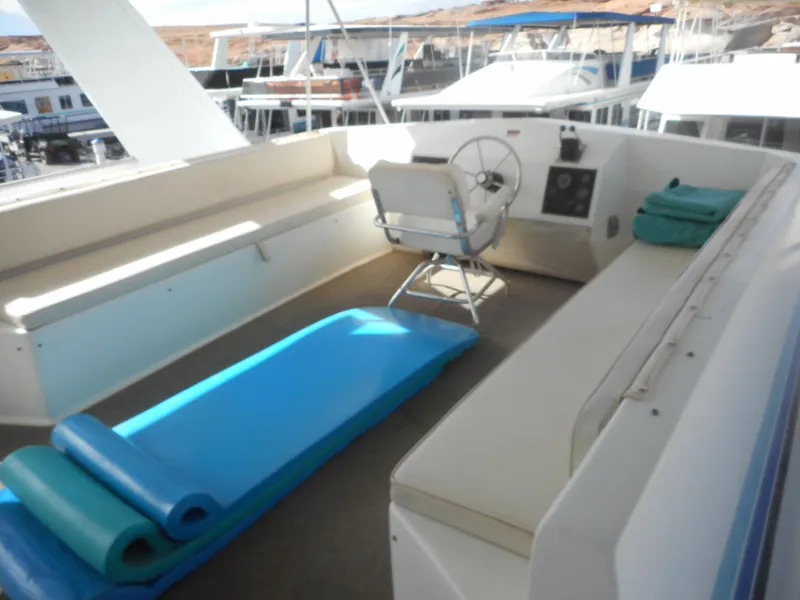 Slide: The Image of 1995 Stardust Cruisers The Verdict houseboat deck with seating and steering wheel. - 41