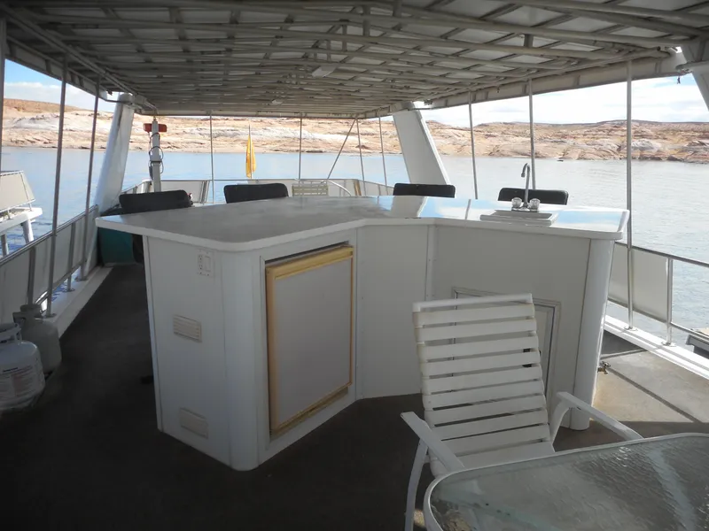 Slide: The Image of 1995 Stardust Cruisers The Verdict houseboat with outdoor bar and seating area. - 44