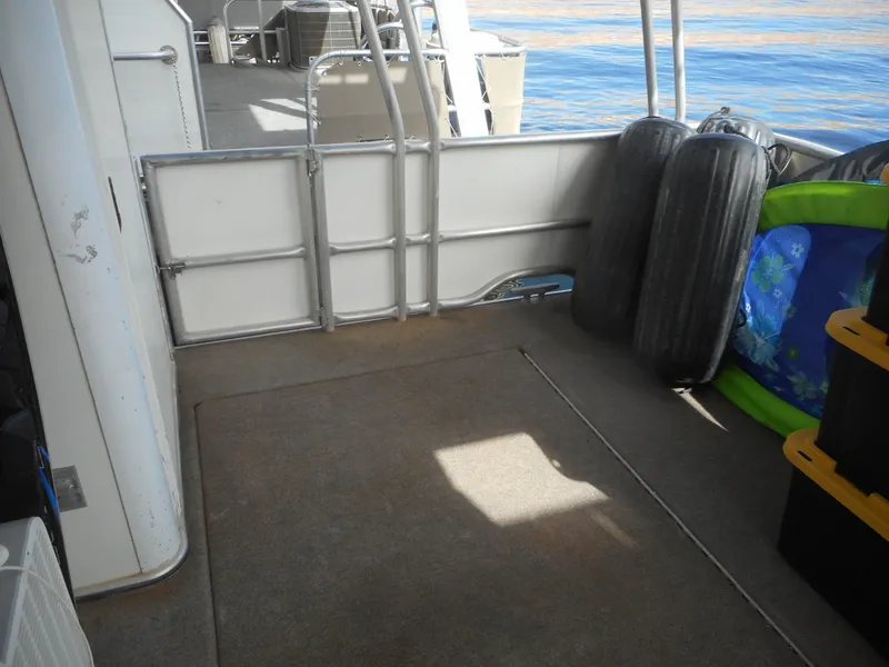 Slide: The Image of 1995 Stardust Cruisers The Verdict boat deck with storage and safety equipment. - 6