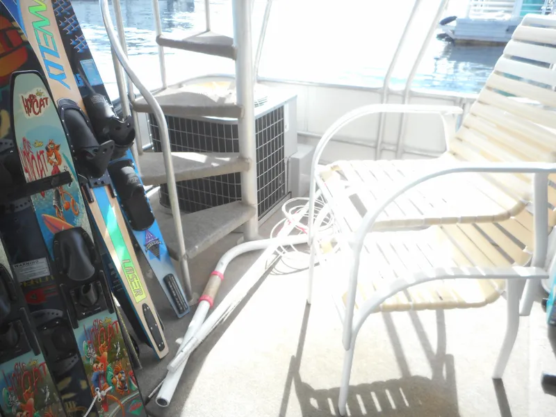 Slide: The Image of Deck of 1995 Stardust Cruisers The Verdict with water skis and chair. - 7
