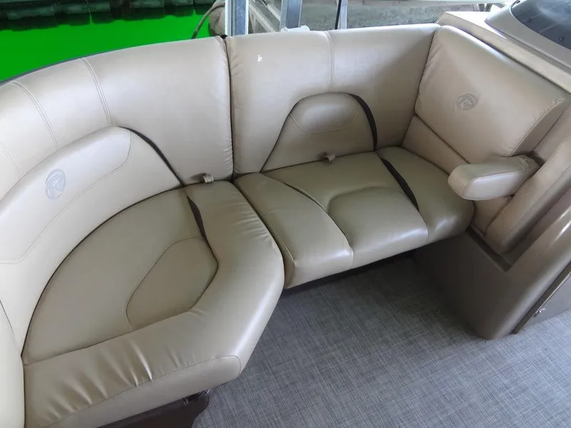 Slide: The Image of 2019 Lowe Retreat 230 RFL boat with beige leather seating. - 10