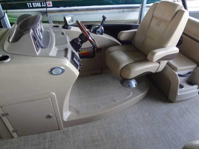 Slide: The Image of 2019 Lowe Retreat 230 RFL boat interior with captain's chair and control console. - 11