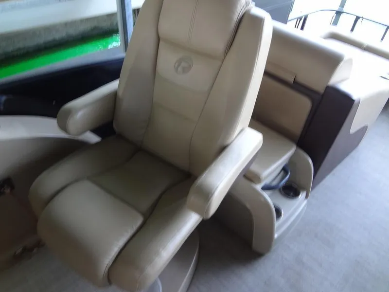 Slide: The Image of 2019 Lowe Retreat 230 RFL boat interior with beige captain's chair. - 13
