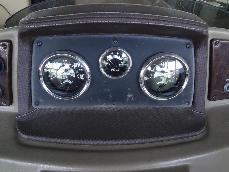 Slide: The Image of 2019 Lowe Retreat 230 RFL dashboard with speedometer, voltmeter, and fuel gauge. - 15