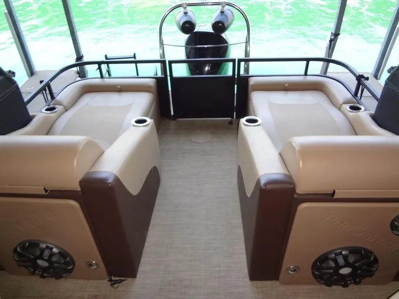 Slide: The Image of 2019 Lowe Retreat 230 RFL boat interior with tan and brown seating. - 17