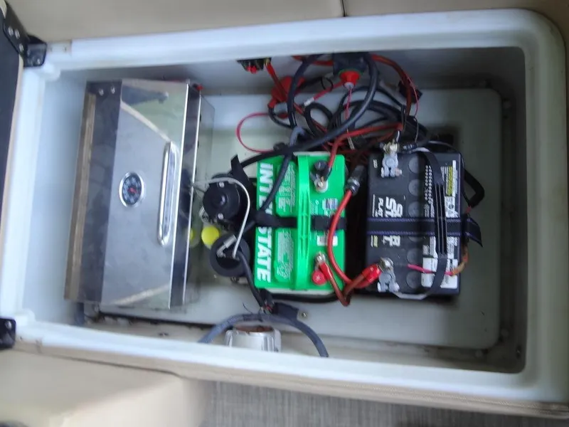 Slide: The Image of 2019 Lowe Retreat 230 RFL battery compartment with wiring and components. - 23