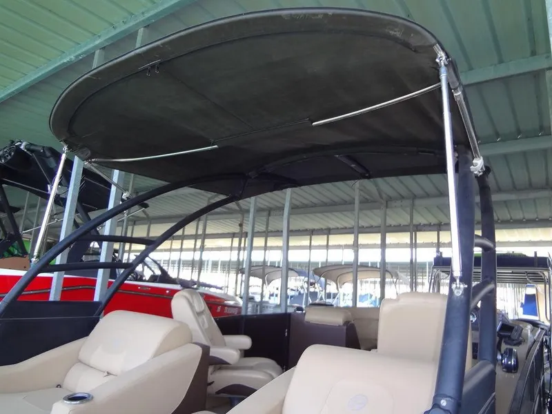Slide: The Image of 2019 Lowe Retreat 230 RFL pontoon boat with canopy and beige seating. - 29