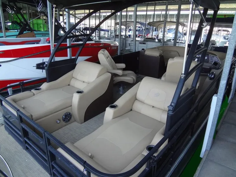 Slide: The Image of 2019 Lowe Retreat 230 RFL pontoon boat with beige seating in marina. - 3