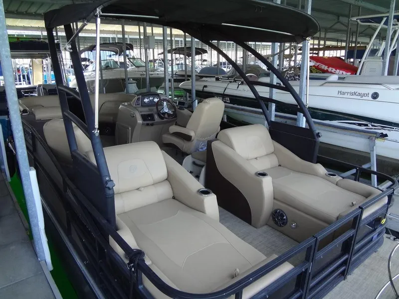 Slide: The Image of 2019 Lowe Retreat 230 RFL pontoon boat with beige seating in marina. - 5