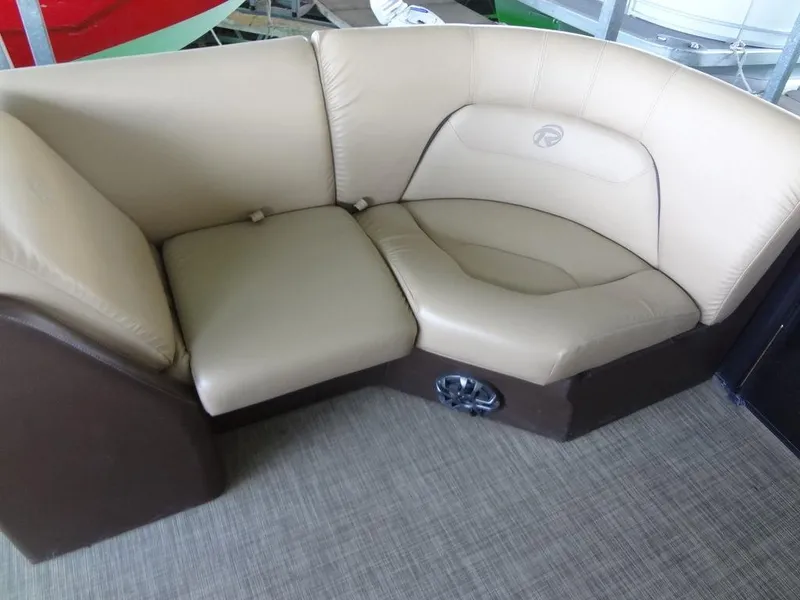 Slide: The Image of 2019 Lowe Retreat 230 RFL boat interior seating with beige and brown upholstery. - 7
