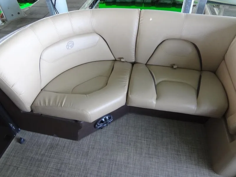 Slide: The Image of 2019 Lowe Retreat 230 RFL beige leather seating area with brown accents. - 9