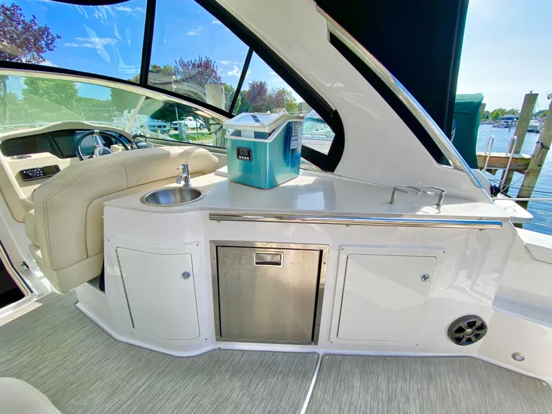 Slide: The Image of 2019 Regal 33 Express boat with beige seating at a marina. - 10