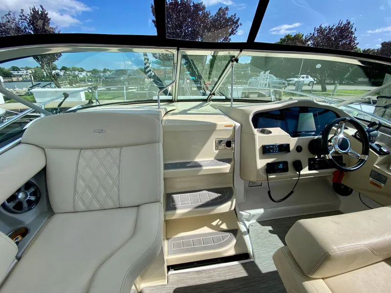 Slide: The Image of Interior of 2019 Regal 33 Express boat with seating, kitchenette, and helm. - 11