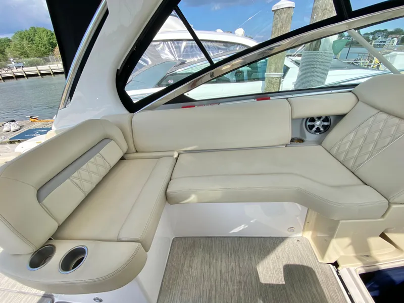 Slide: The Image of 2019 Regal 33 Express boat interior with beige leather seating. - 12