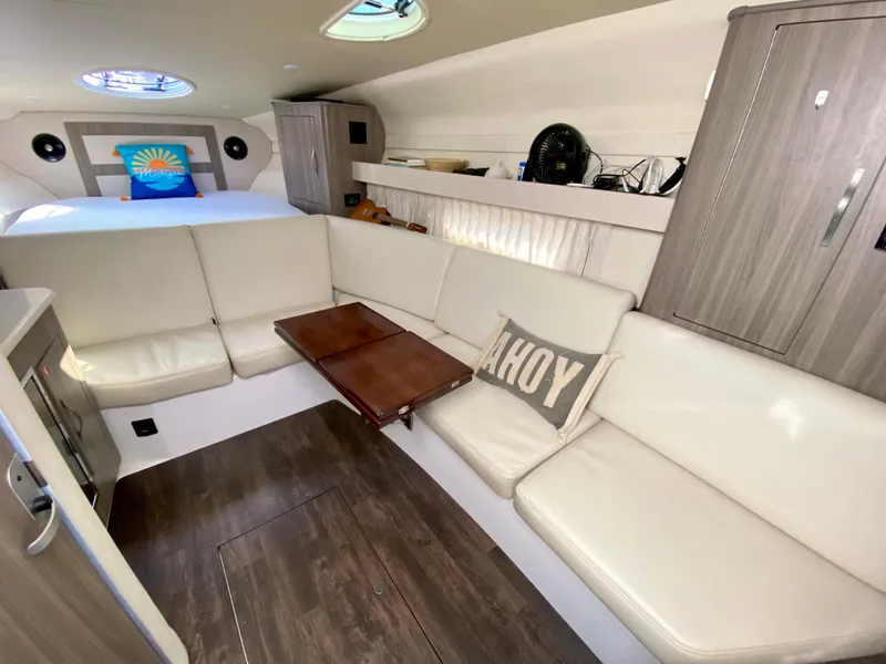 Slide: The Image of 2019 Regal 33 Express boat cockpit with steering wheel and beige seating. - 15