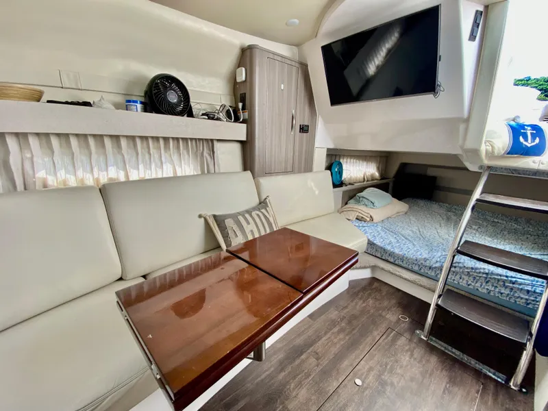 Slide: The Image of 2019 Regal 33 Express cabin with bed, seating, and storage. - 19