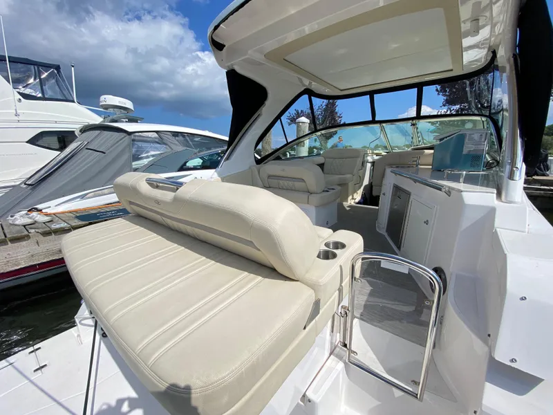 Slide: The Image of 2019 Regal 33 Express cabin with cozy bed and nautical-themed bedding. - 4