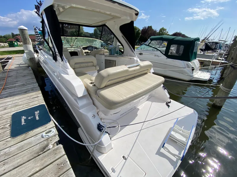 Slide: The Image of 2019 Regal 33 Express boat with beige seating at a marina. - 8
