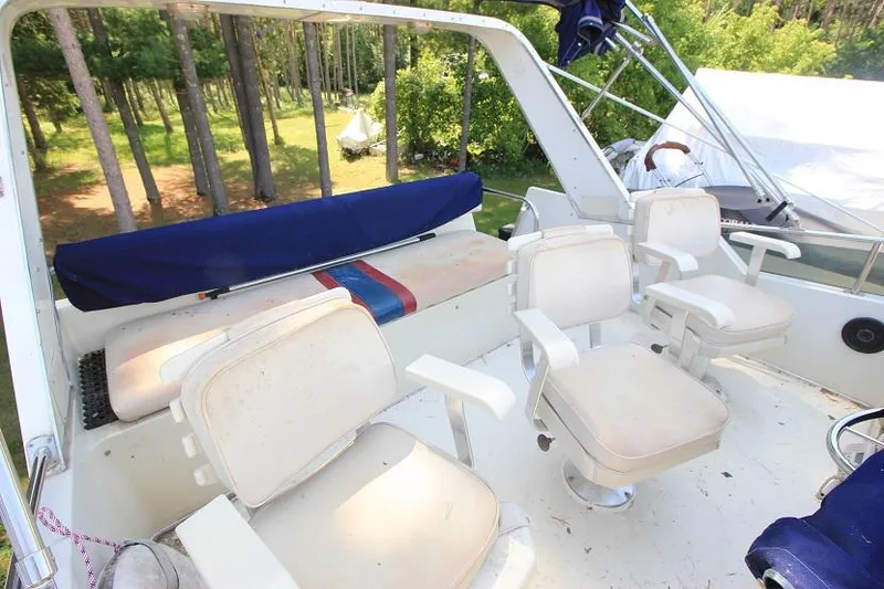 Slide: The Image of 1989 Tollycraft 30 Sport Cruiser deck with seating and outdoor view. - 10