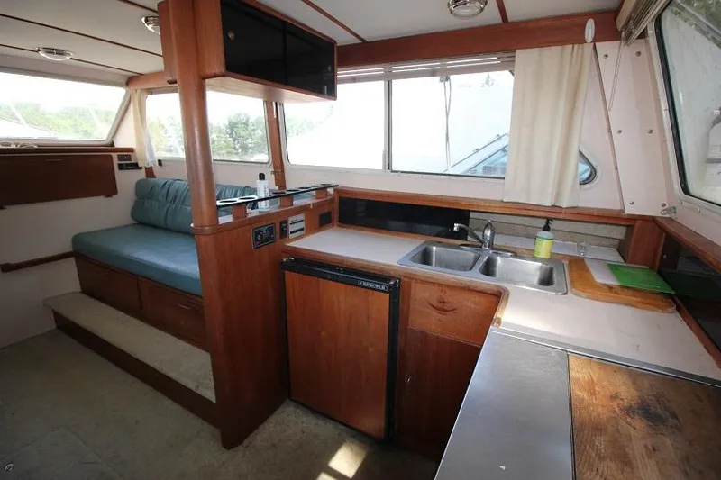 Slide: The Image of Interior of 1989 Tollycraft 30 Sport Cruiser with kitchen and seating area. - 18