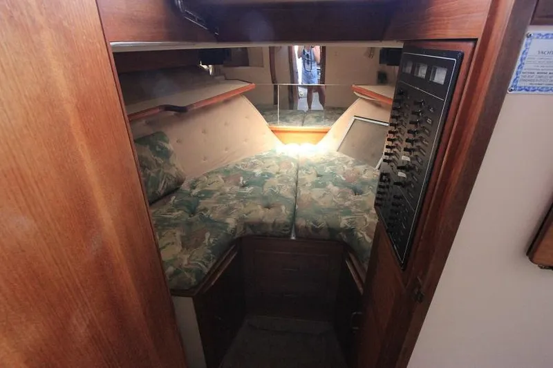 Slide: The Image of 1989 Tollycraft 30 Sport Cruiser cabin with V-berth and control panel. - 22