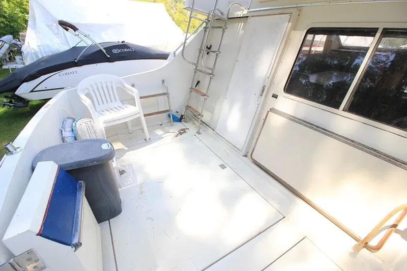 Slide: The Image of 1989 Tollycraft 30 Sport Cruiser deck with seating and storage. - 3