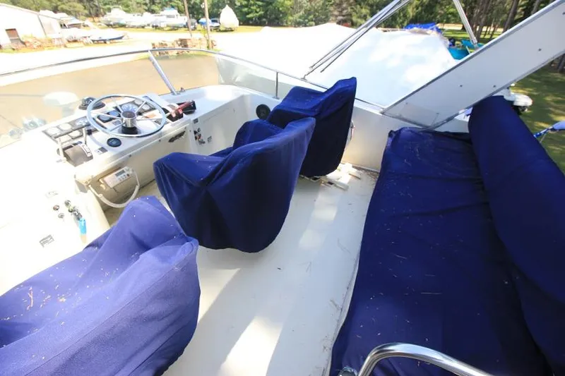 Slide: The Image of 1989 Tollycraft 30 Sport Cruiser cockpit with blue seat covers and steering wheel. - 6