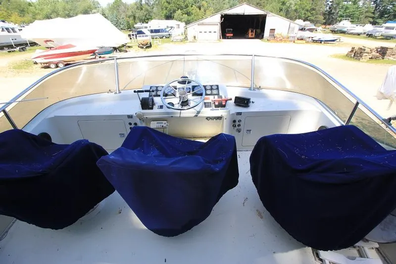 Slide: The Image of 1989 Tollycraft 30 Sport Cruiser helm with covered seats and control panel. - 7