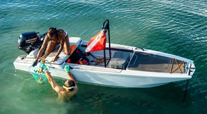 Slide: The Image of 2024 Veer V13 boat with people snorkeling in clear water. - 1