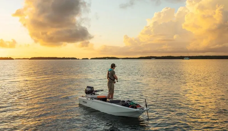 Slide: The Image of Man fishing on a Veer V13 boat at sunset, 2024 model. - 2