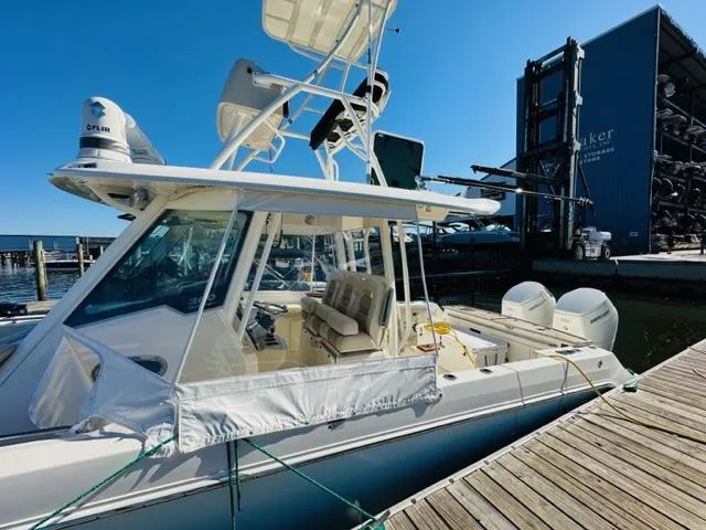 Slide: The Image of 2023 Boston Whaler 360 Outrage docked at marina, side view. - 10
