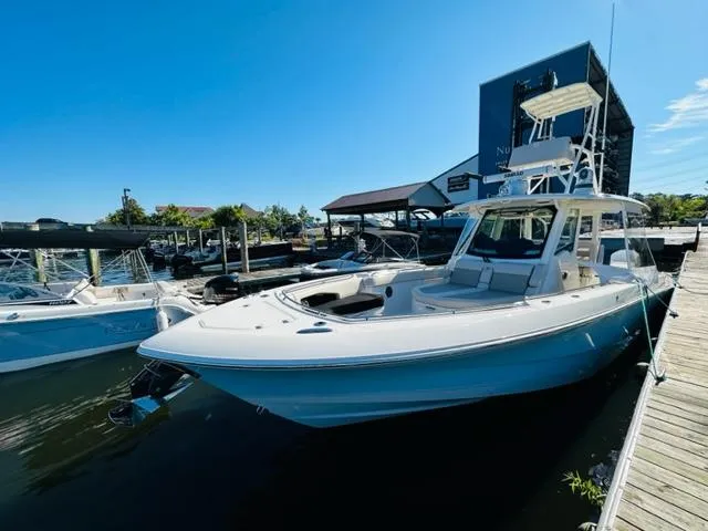 Slide: The Image of 2023 Boston Whaler 360 Outrage docked at a marina on a sunny day. - 11