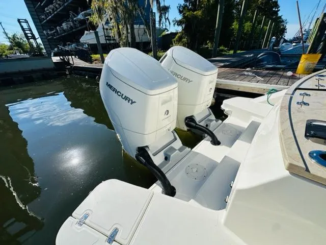 Slide: The Image of 2023 Boston Whaler 360 Outrage with twin Mercury outboard engines docked. - 14