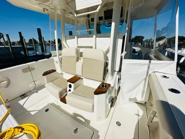 Slide: The Image of 2023 Boston Whaler 360 Outrage boat interior with seating and helm station. - 16