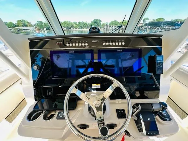 Slide: The Image of Helm of 2023 Boston Whaler 360 Outrage with advanced navigation systems. - 22